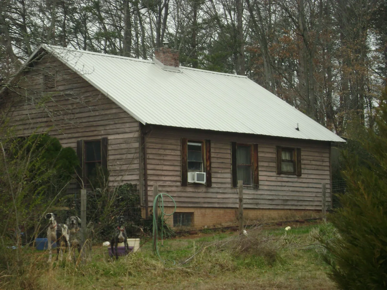 White metal roof on an old wood sided farmhouse, from a Metal Roof Installation job in Elkmont